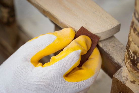 Sanding The Paint Of An Old Furniture to prepare for upcycling pine furniture